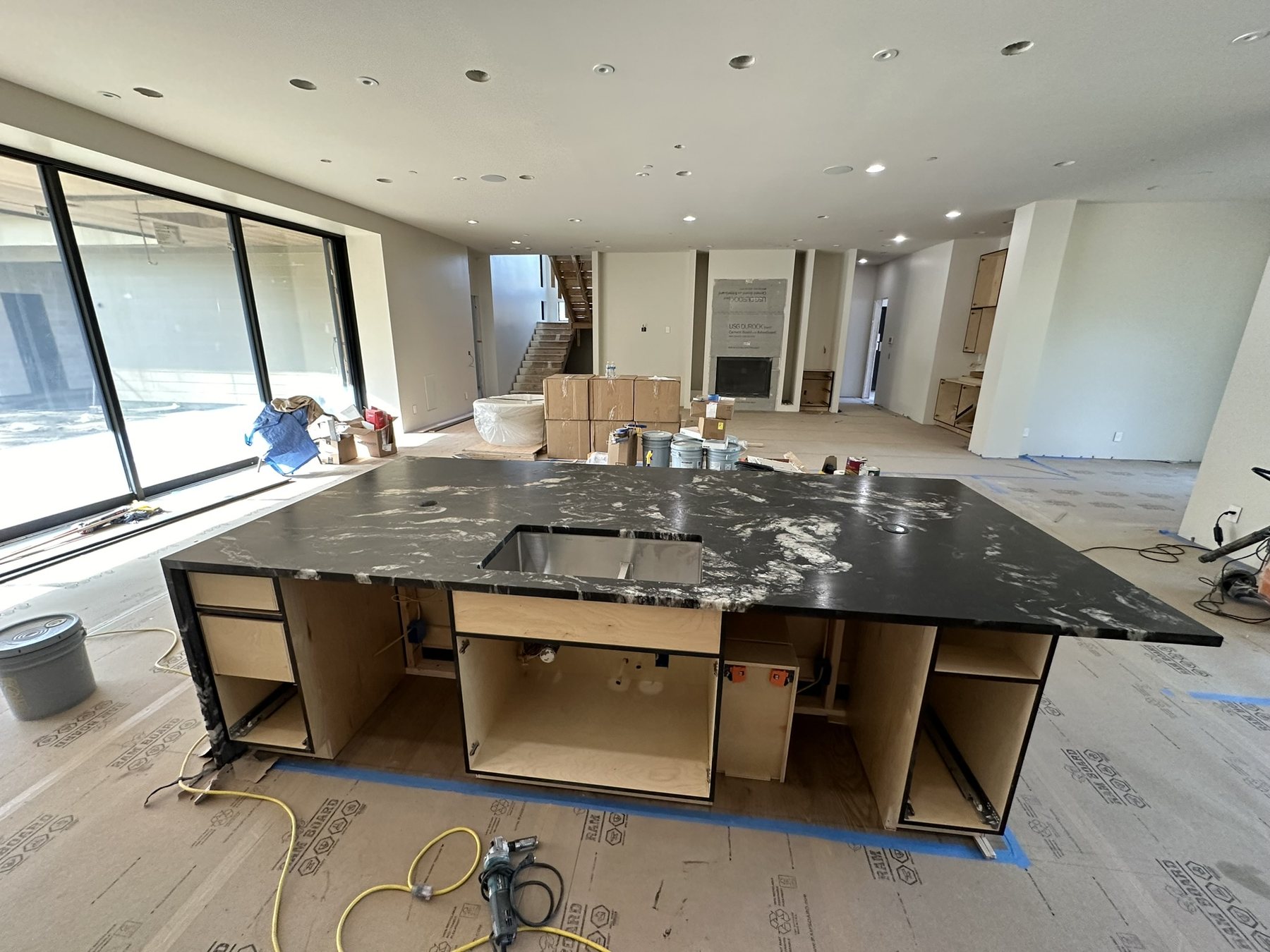 Large dark stone kitchen island with custom cabinetry